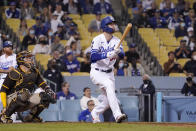 Los Angeles Dodgers' Cody Bellinger, right, watches along with San Diego Padres catcher Victor Caratini as he hits a solo home run during the eighth inning of a baseball game Wednesday, Sept. 29, 2021, in Los Angeles. (AP Photo/Mark J. Terrill)