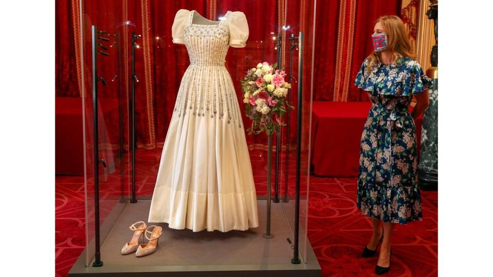 Princess Beatrice posing alongside her wedding dress as it goes on display at Windsor Castle