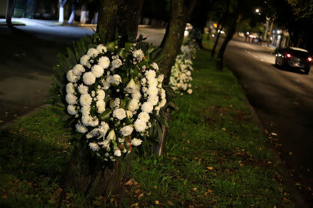 Floral wreaths for the students of the Enrique Rebsamen school are seen attached to trees, after an earthquake in Mexico City, Mexico September 22, 2017. REUTERS/Jose Luis Gonzalez/Files