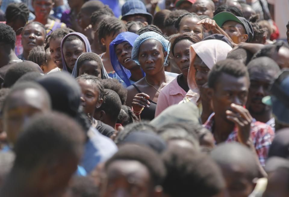 People line up to receive food at a shelter for families displaced by gang violence, in Port-au-Prince, Haiti, Thursday, March 14, 2024. (AP Photo/Odelyn Joseph)