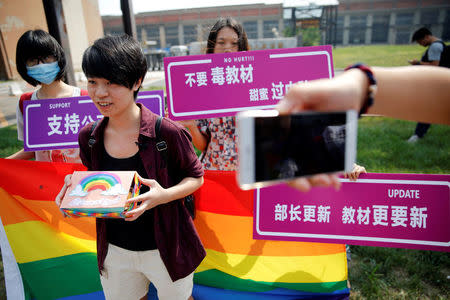 Qiu Bai, a Chinese student who lodged a suit against the Ministry of Education over school textbooks describing homosexuality as a mental disorder, shows the present she prepared for officials near the courthouse before the hearing in Beijing, China September 12, 2016. REUTERS/Damir Sagolj