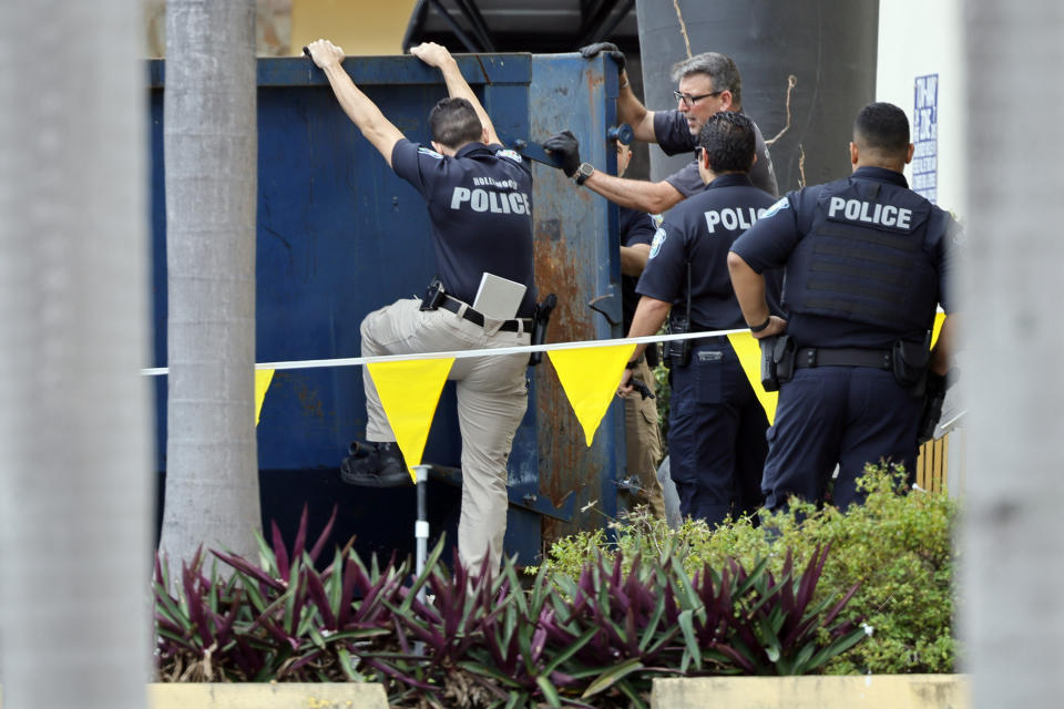 Crime scene investigators close the door to a large trash bin outside of an apartment complex in Hollywood, Fla., where construction workers found a dead baby on Monday, Jan. 8, 2024. (Amy Beth Bennett/South Florida Sun-Sentinel via AP)