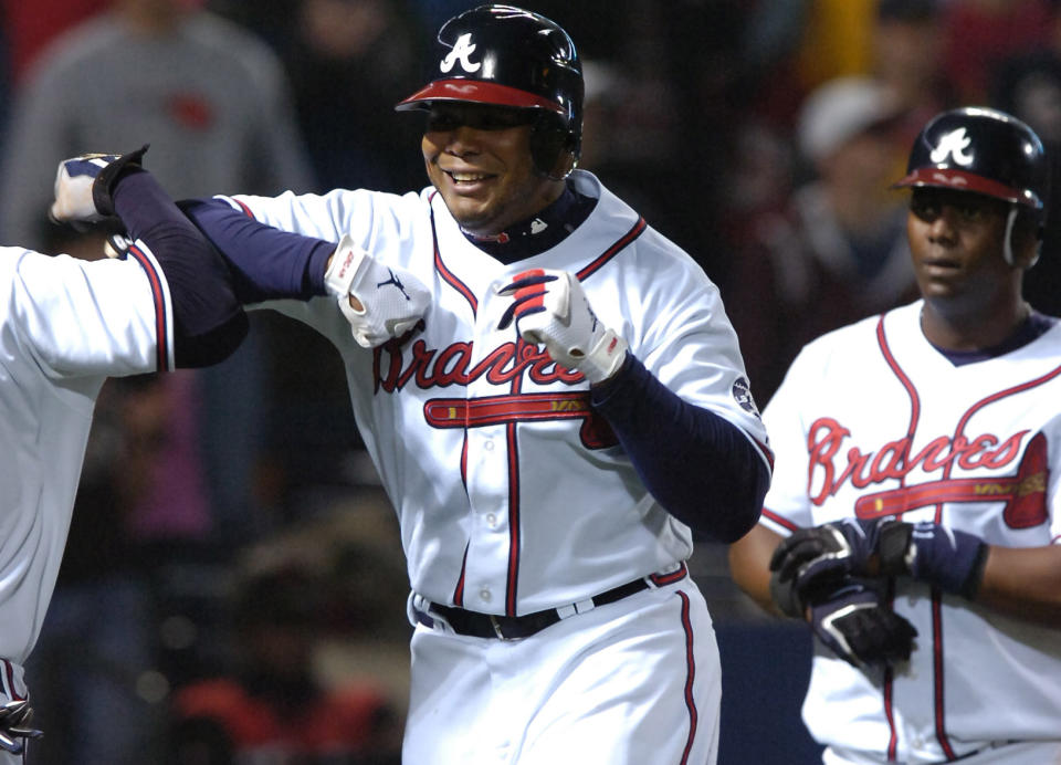 FILE - Atlanta Braves' Andruw Jones is congratulated by Chipper Jones, left, after his three-run homer in the seventh inning of a baseball game against the Washington Nationals as Edgar Renteria watches, on April 11, 2007, in Atlanta. The Atlanta Braves will retire No. 25 in honor of Jones later this season. The Braves announced Monday, April 3, 2023, the outfielder will be honored in a special number retirement ceremony Sept. 9. During his 12 seasons with the Braves, Jones won 10 consecutive Gold Glove Awards. He was voted to the All-Star Team five times. (W.A. Bridges/Atlanta Journal-Constitution via AP, File)