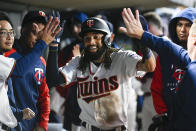 Minnesota Twins' Billy Hamilton is congratulated in the dugout after he scored against the Chicago White Sox during the eighth inning of a baseball game Wednesday, Sept. 28, 2022, in Minneapolis. The Twins won 8-4. (AP Photo/Craig Lassig)
