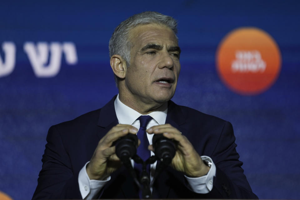 Israeli Prime Minister and the head of Yesh Atid party, Yair Lapid, speaks to his supporters after first exit poll results for the Israeli Parliamentary election at his party's headquarters in Tel Aviv, Israel, Wednesday, Nov. 2, 2022. (AP Photo/Ariel Schalit)