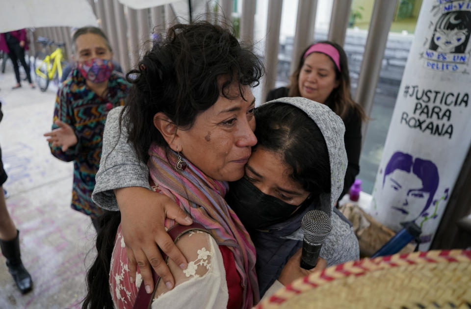 Roxana Ruiz, right, is hugged by Araceli Osorio Martinez, the mother of murdered Lesvy Berlin Osorio, outside a court on the day of Roxana's hearing where she is accused of killing a man in 2021 who she says raped her and threatened her life, in Chimalhuacán, State of Mexico, Mexico, Monday, Abril 18, 2022. Lesvy’s body was found on the campus of the National Autonomous University of Mexico (UNAM), and the autopsy determined she was strangled by a telephone cable. Her then-boyfriend Jorge Luis González Hernández was convicted of femicide and sentenced to 52 years in prison. (AP Photo/Eduardo Verdugo)