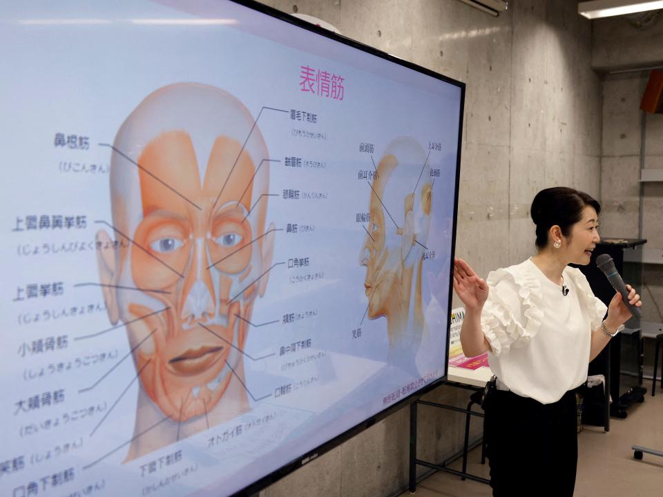 Smile coach Keiko Kawano teaches students at a smile training course at Sokei Art School in Tokyo, Japan, May 30, 2023.