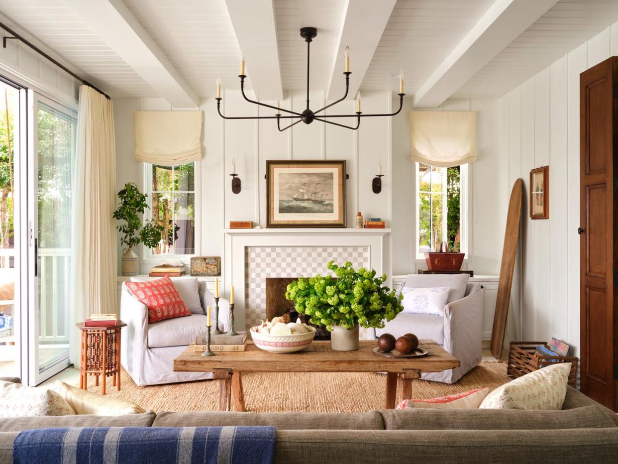 a living room with a white fireplace and wood coffee table