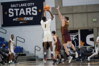 San Francisco guard Jamaree Bouyea (1) shoots as Loyola forward Ryan Schwieger (13) defends in the first half during an NCAA college basket ball game Thursday, Jan. 6, 2022, in Taylorsville, Utah. Struggling to find opponents amid the coronavirus chaos, San Francisco and Loyola Chicago decided to meet in the middle. (AP Photo/Rick Bowmer)