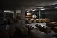 Coffins carrying the bodies of people who died of coronavirus are stored waiting to be buried or incinerated in an underground parking lot at the Collserola funeral home in Barcelona, Spain, April 2, 2020. (AP Photo/Felipe Dana)