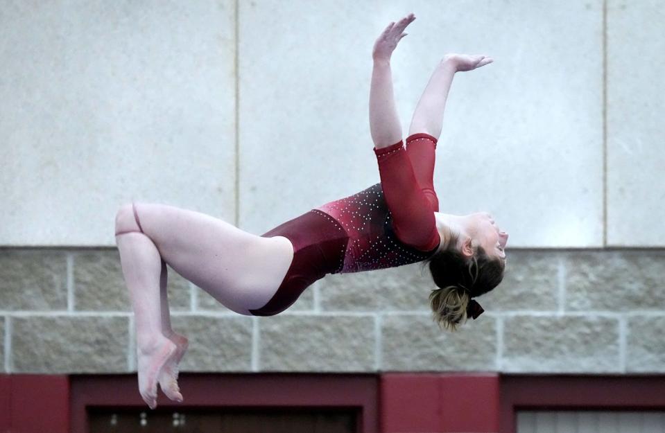 Lauren Horrigan of La Salle executes a backflip on the balance beam on her way to winning the All-Around title at the State Gymnastics Championship at Rhode Island College on Saturday.