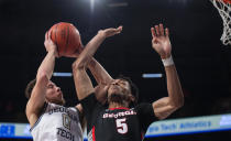 Georgia Tech guard Lance Terry shoots next to Georgia center Frank Anselem during the second half of an NCAA college basketball game Tuesday, Dec. 6, 2022, in Atlanta. (AP Photo/Hakim Wright Sr.)