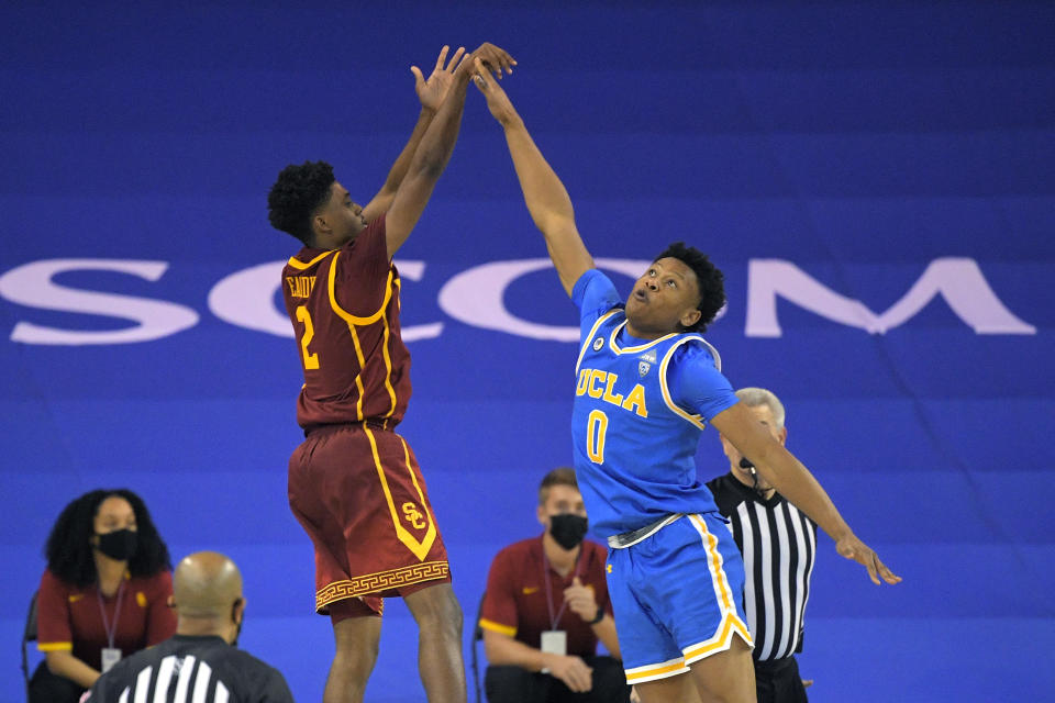 Southern California guard Tahj Eaddy, left, shoots and makes a game-winning three-point shot as UCLA guard Jaylen Clark defends during the second half of an NCAA college basketball game Saturday, March 6, 2021, in Los Angeles. USC won 64-63. (AP Photo/Mark J. Terrill)