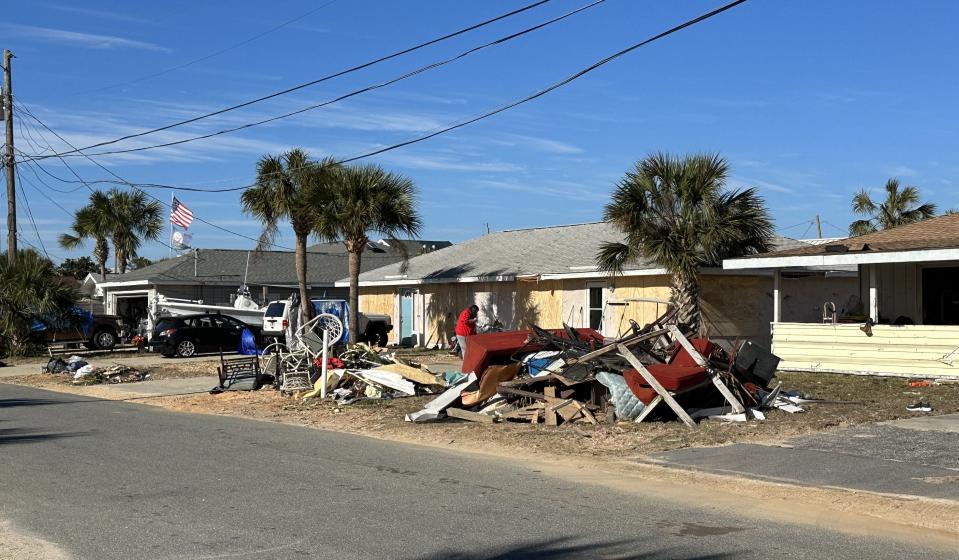 Folks were piling up damaged belongings along the roads after the storm on Wednesday.