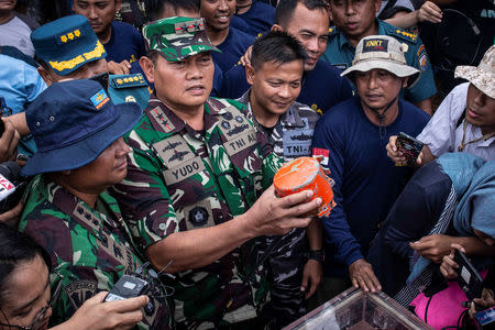 Indonesia's Navy Commander Rear Admiral Yudo Margono holds the cockpit voice recorder (CVR) of a Lion Air JT610 that crashed into Tanjung Karawang sea, on the deck of Indonesia's Navy ship KRI Spica-934 at Karawang sea in West Java, Indonesia, January 14, 2019 in this photo taken by Antara Foto. Antara Foto/Aprillio Akbar/via REUTERS