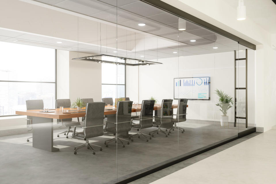 Outside view of empty meeting room with table and office chairs