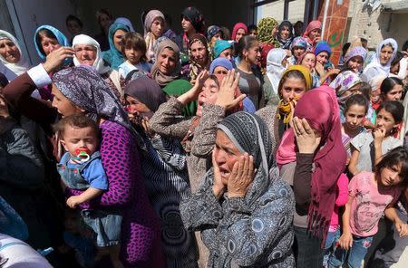 Relatives mourn during the funeral of two Syrian toddlers who drowned with their mother as they were trying to reach Greece, at the Syrian border town of Kobani September 4, 2015. The toddlers, including three-year-old Aylan Kurdi, were laid to rest in the Syrian town of Kobani on Friday, a Reuters witness said. Abdullah Kurdi, their father, wept as their bodies were buried alongside each other in the "Martyrs' Ceremony" in the predominantly Kurdish town of Kobani, also known as Ayn al-Arab, near at the border with Turkey. REUTERS/Rodi Said