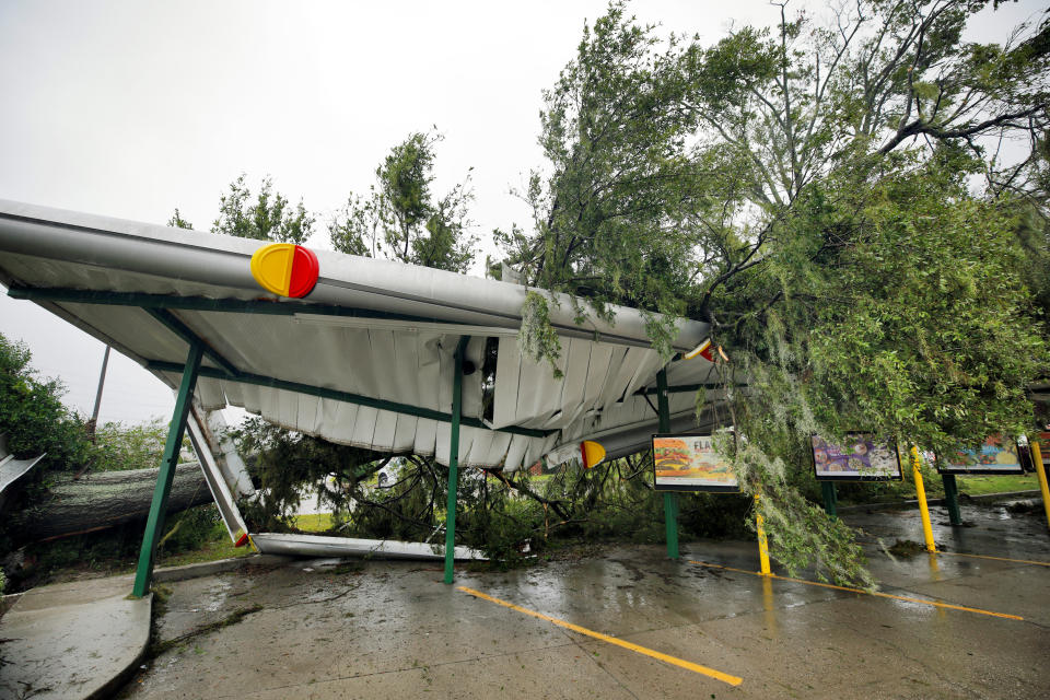 A fallen tree lies atop the crushed roof of a fast food restaurant after the arrival of Hurricane Florence in Wilmington, North Carolina on Friday.