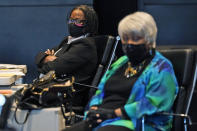 Virginia State Sen. Maime Locke, D-Hampton, left, listens along with Sen. Louise Lucas, D-Portsmouth, right, during debate on a bill calling for the removal of the statue of former Senator Harry F. Byrd Sr. from Capitol Square during the Senate session at the Science Museum of Virginia in Richmond, Va., Tuesday, Feb. 23, 2021. The Senate passed the measure. (AP Photo/Steve Helber)