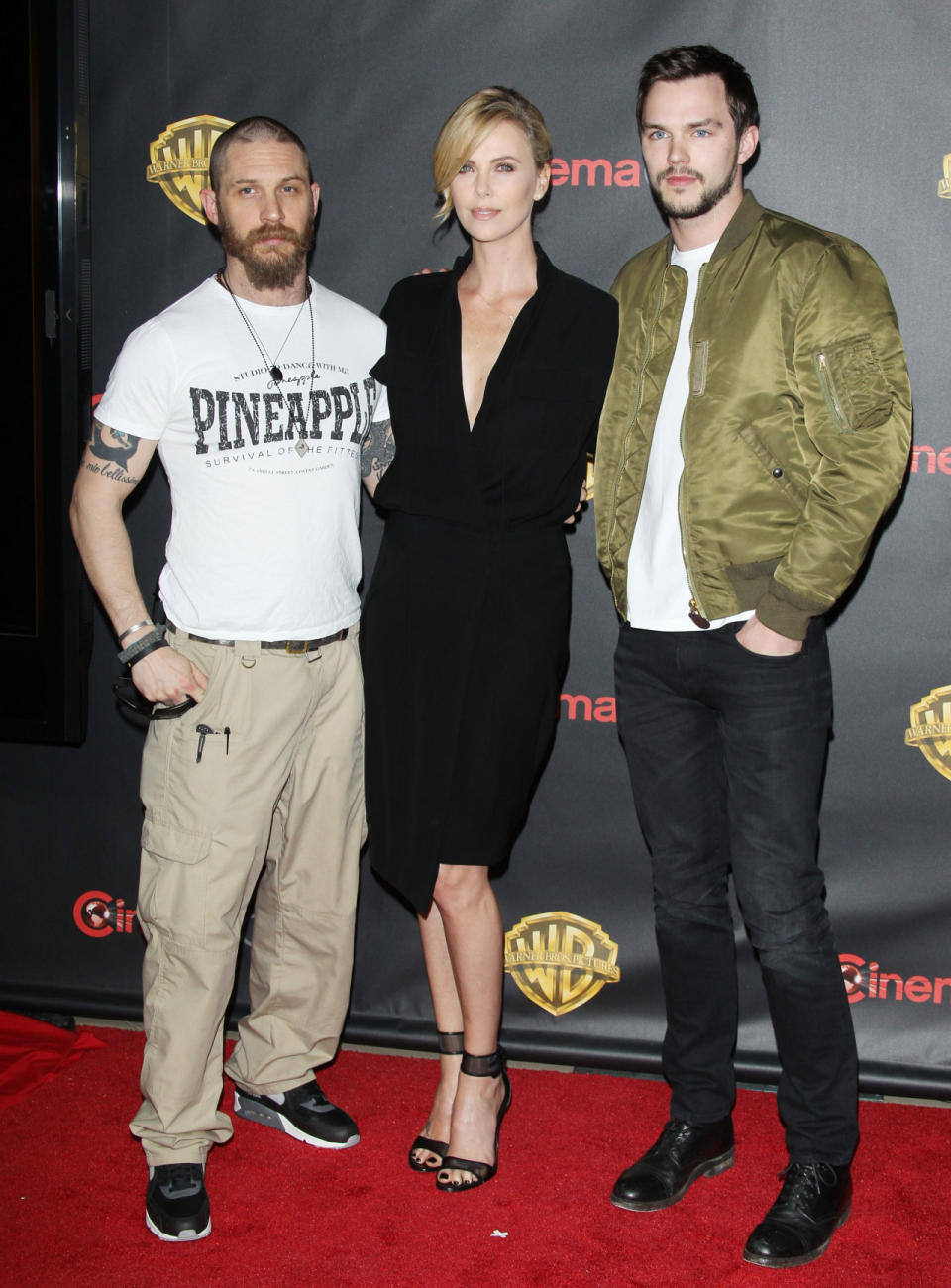 The co-stars in the upcoming remake of “Mad Max” seemed to have gotten different dress codes on their invitations. Tom Hardy’s unkempt beard, ‘90s cargo pants, and “pineapple” T-shirt ensemble appeared more appropriate for, well, no where while Nicholas Hoult, in dark jeans and an army green satin bomber jacket was casual cool. Charlize Theron, on the other hand, was totally glam in a black wrap dress from Alexandre Vauthier.