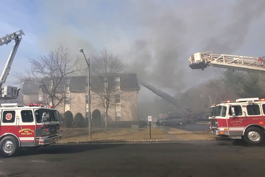 Firefighters work to put out a residential building fire in South Brunswick, NJ, on March 7, 2022. (Monmouth Junction Fire Department)