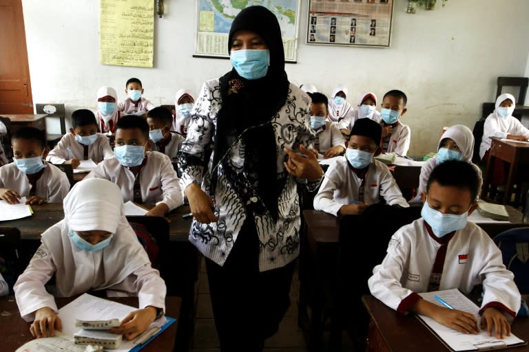 Indonesian teacher and students are seen wearing face masks to protect themselves against air pollution in Palembang, southern Sumatra province, on October 8, 2015