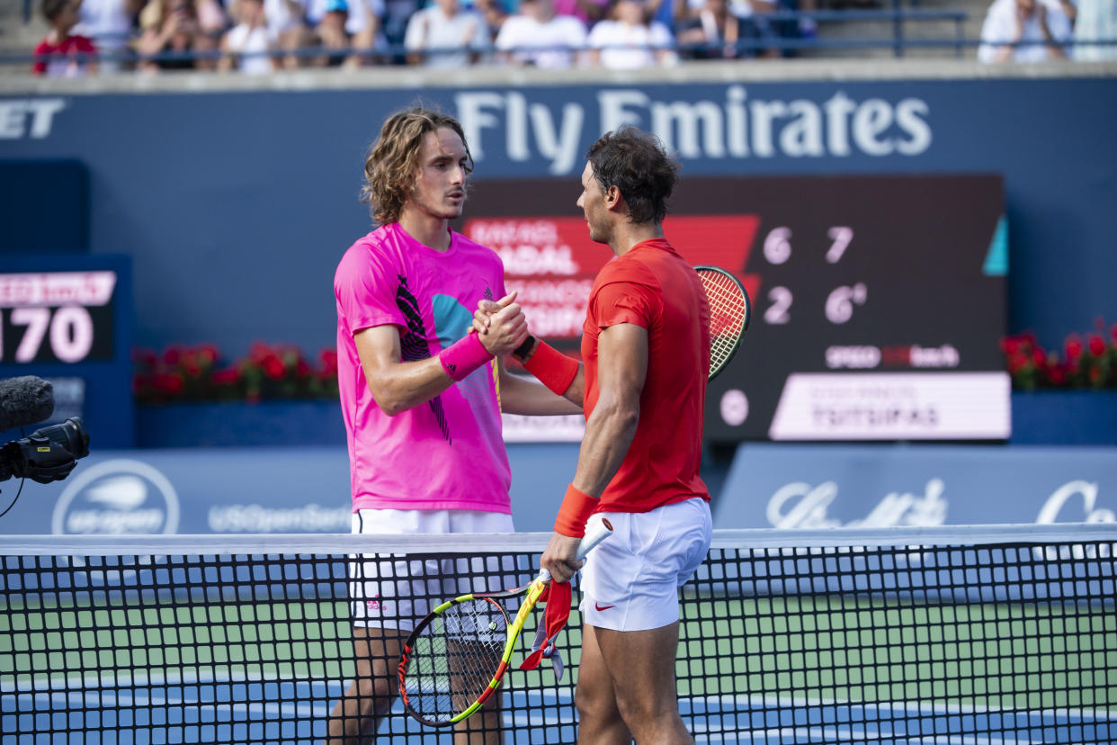 Rafael Nadal and Stefanos Tsitsipas embrace at the net after their Rogers Cup final