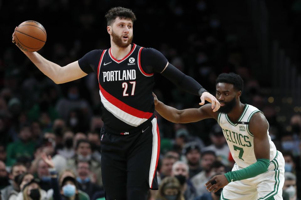 Portland Trail Blazers' Jusuf Nurkic (27) keeps the ball away from Boston Celtics' Jaylen Brown (7) during the first half of an NBA basketball game Friday, Jan. 21, 2022, in Boston. (AP Photo/Michael Dwyer)