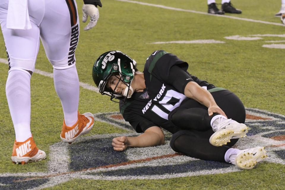 New York Jets quarterback Trevor Siemian (19) grabs his leg after being hurt during the first half of an NFL football game against the Cleveland Browns, Monday, Sept. 16, 2019, in East Rutherford, N.J. (AP Photo/Bill Kostroun)