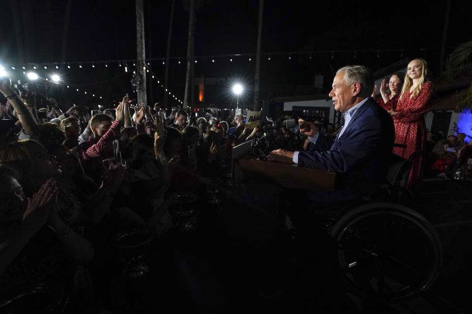 Texas Gov. Greg Abbott speaks during an election night party Tuesday, Nov. 8, 2022, in McAllen, Texas, accompanied by his wife Cecilia Abbott and daughter Audrey. (AP Photo/David J. Phillip)