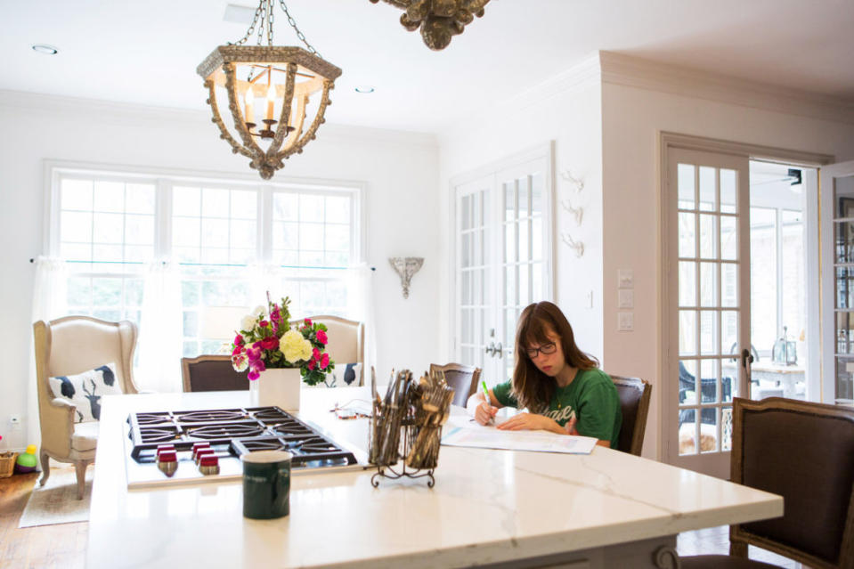 Anna Hammett, 14, does her homework in the kitchen of her home in Houston.