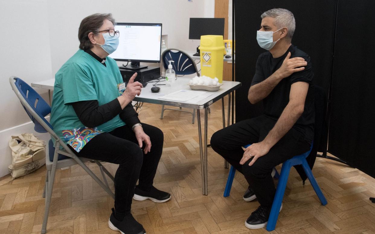 Mayor of London Sadiq Khan receives his first dose of the Pfizer vaccine from Dr. Sue Clarke  - PA