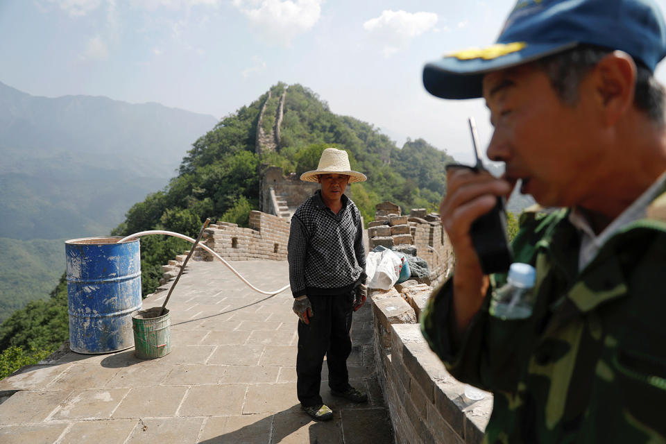 <p>People pause from working on the reconstruction of the Jiankou section of the Great Wall, located in Huairou District, north of Beijing, China, June 7, 2017. (Photo: Damir Sagolj/Reuters) </p>