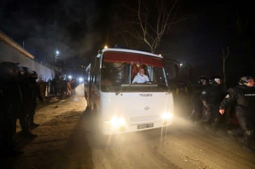 Protesters hurled hurled stones at vehicles carrying evacuees from China and bound for a medical facility in Novi Sanzhary