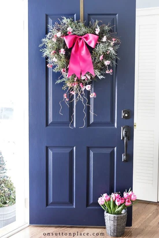 a blue door with a wreath on it