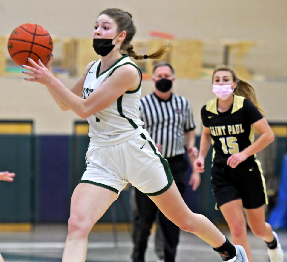 Wachusett's Emmy Allyn dishes off a pass after getting past St. Paul's Mia Kreidler.