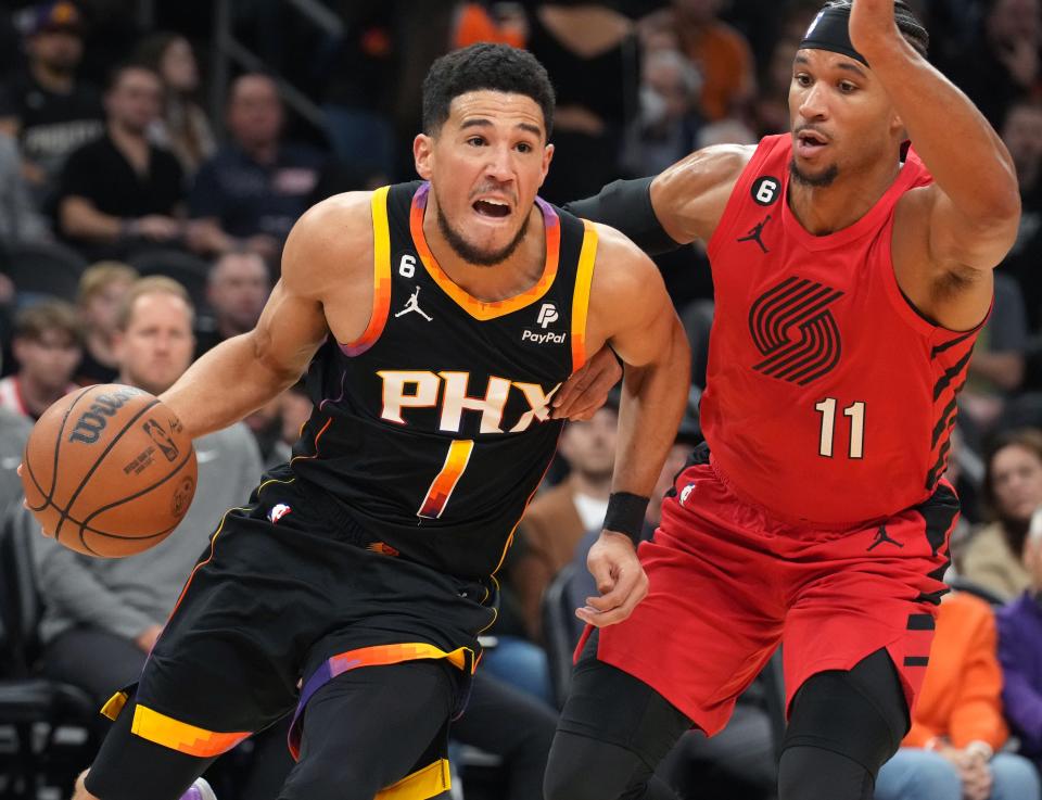 Nov 4, 2022; Phoenix, AZ, USA; Phoenix Suns guard Devin Booker (1) drives past Portland Trail Blazers guard Josh Hart (11) at Footprint Center. Mandatory Credit: Joe Rondone-Arizona Republic