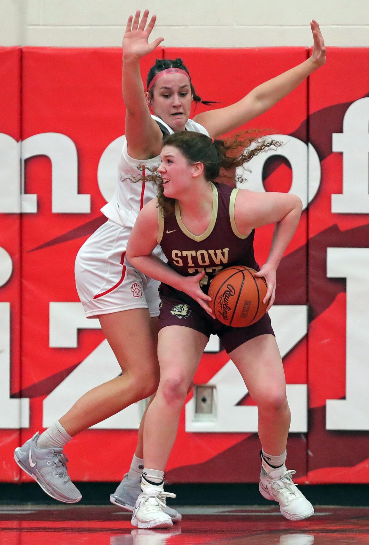 Stow's Kennady Dodds, bottom, looks to the basket under Wadsworth's Lyla Wilson on Dec. 13, 2023, in Wadsworth.