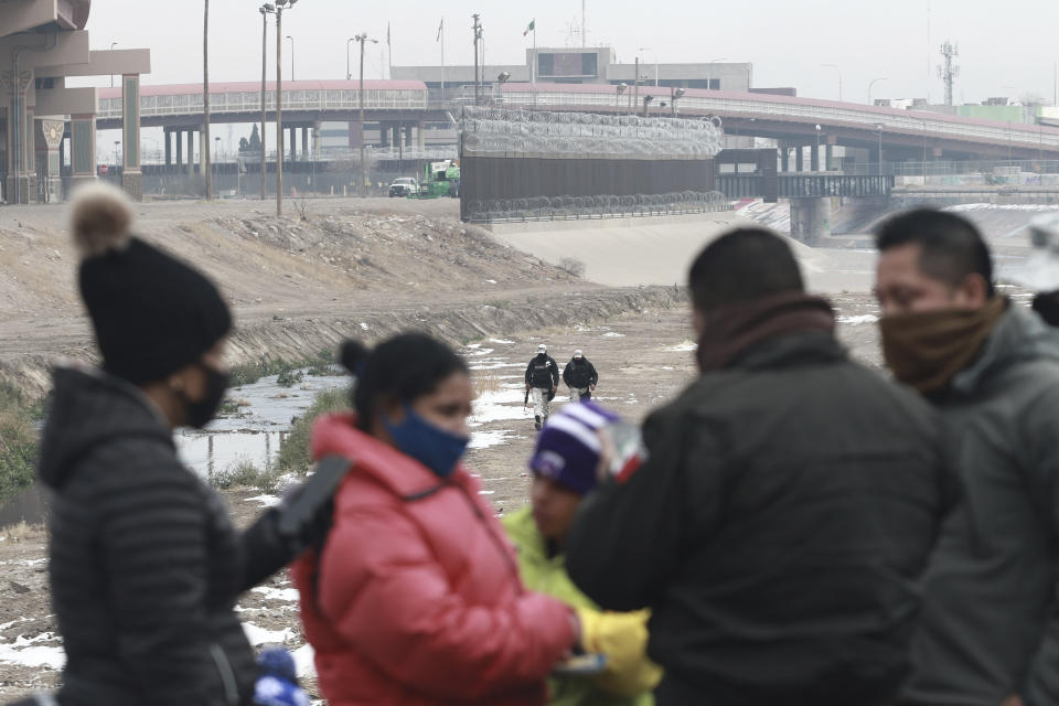 A Cuban migrant family is detained by National Guard soldiers along the Rio Grande in Ciudad Juarez, Mexico, Tuesday, Feb. 16, 2021. The number of people apprehended at the U.S.-Mexico border has increased since January and January was above December. This week families have been seen crossing from Ciudad Juarez and turning themselves over to Border Patrol. (AP Photo/Christian Chavez)