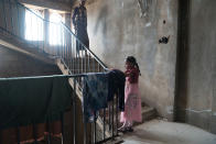 <p>Al Abthi building, Ibb City, Yemen, April 21, 2017: A young girl and her father on the stairs of a former government building in the suburbs of Ibb. The building was provided by local authorities to house 53 displaced families who fled here from Taizz after heavy fighting flared up in the summer of 2015. The building has no electricity or running water. The displaced families installed solar panels on the roof of the building to provide power for rudimentary lighting at night. Many of the children help their parents by collecting water and tending to the younger children in the building. (Photograph by Giles Clarke for UN OCHA/Getty Images) </p>