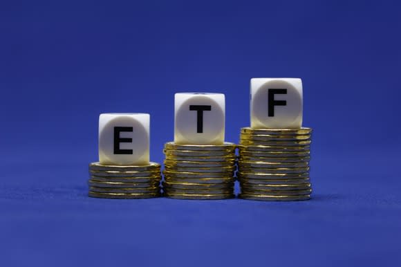 Letter cubes marked E, T, and F on top of growing piles of coins.