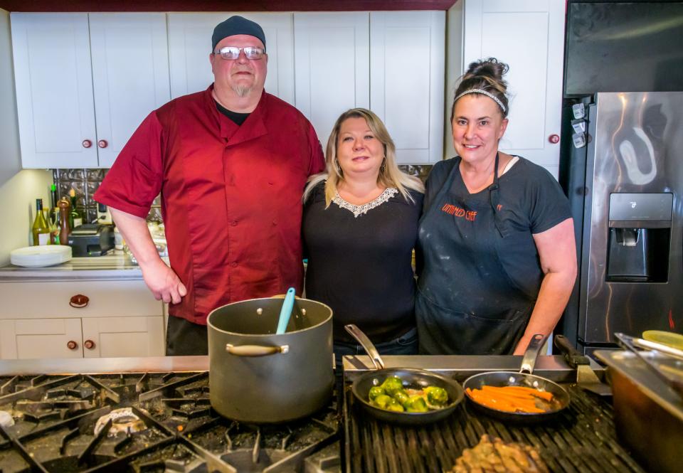 Rebecca Hearn, owner and head chef of the Untamed Chef, stands with her top employees, kitchen lead Mike Moore, left, and sous-chef Jennifer Rennolett in the kitchen of the Peoria restaurant. Hearn's biggest challenge since expanding to dinner hours has been finding enough staff.