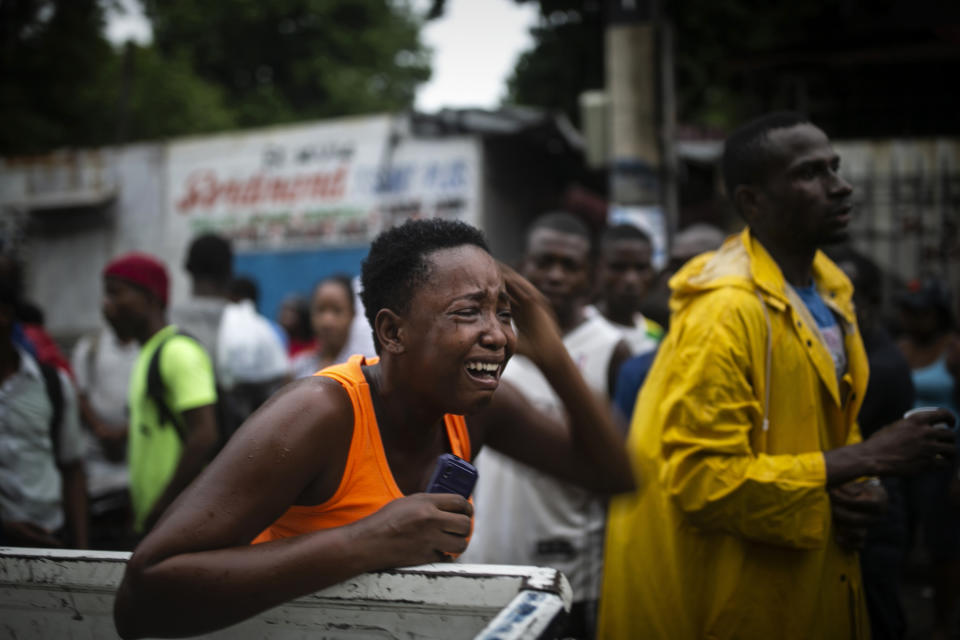 A relative of Rigueur Pierre Richard, who was killed in a drive-by shooting two blocks from the national palace, is overcome with grief during a protest against fuel shortages and demanding the resignation of President Jovenel Moise in Port-au-Prince, Haiti, Sept. 20, 2019. The image was part of a series of photographs by Associated Press photographers which was named a finalist for the 2020 Pulitzer Prize for Breaking News Photography. (AP Photo/Dieu Nalio Chery)