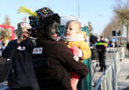 "Zwarte Piet" (Black Pete), who is a Saint Nicholas' assistant is seen during a traditional parade in Zaanstad, Netherlands, November 17, 2018. Picture taken November 17, 2018. REUTERS/Eva Plevier