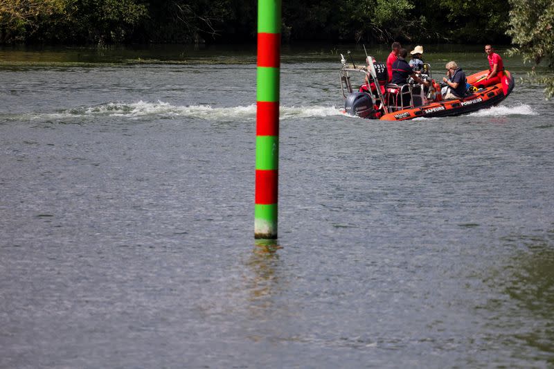 Rescue divers from the firefighter department patrol in search for lost Beluga whale, in Les Andelys