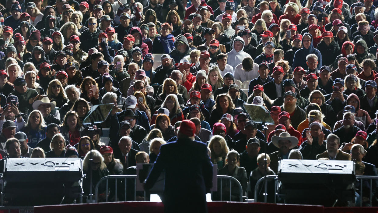 Former President Donald Trump faces a crowd at a rally.