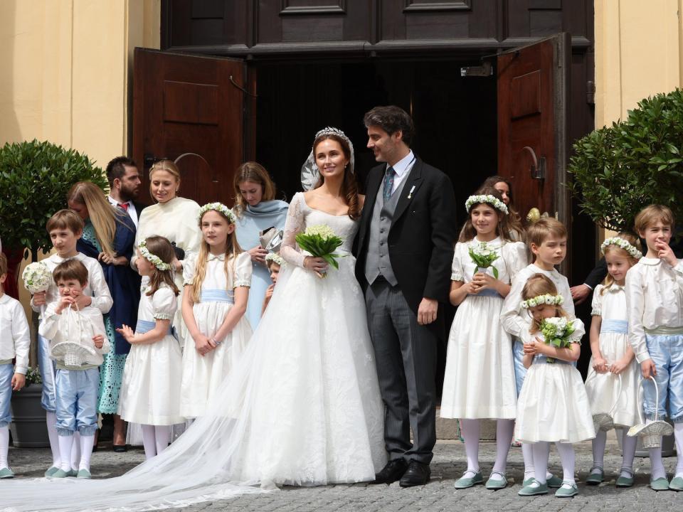 Ludwig Prince of Bavaria and his wife Sophie-Alexandra Princess of Bavaria stand with flower children and page boys in front of the Theatinerkirche after their church wedding.