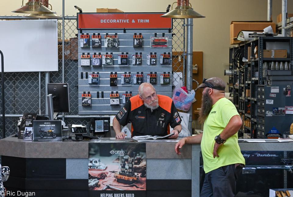 Reid Powers, left, helps John May of Hagerstown with parts at the Harley-Davidson store in the Bowman Business Park. The dealership will be closing it's doors on August 31.