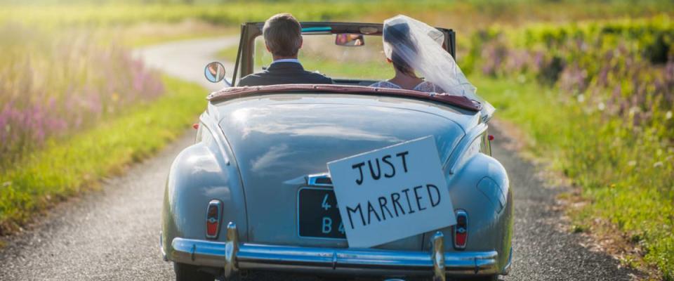 just married vintage car with cans attached to back