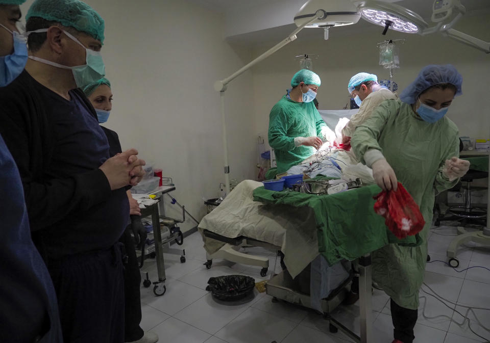 Doctors perform surgery in a basement of a hospital during shelling by Azerbaijan's artillery in Stepanakert, the separatist region of Nagorno-Karabakh, Wednesday, Oct. 28, 2020. Nagorno-Karabakh officials said Azerbaijani forces hit Stepanakert, the region's capital, and the nearby town of Shushi with the Smerch long-range multiple rocket systems, killing one civilian and wounding two more. (AP Photo)